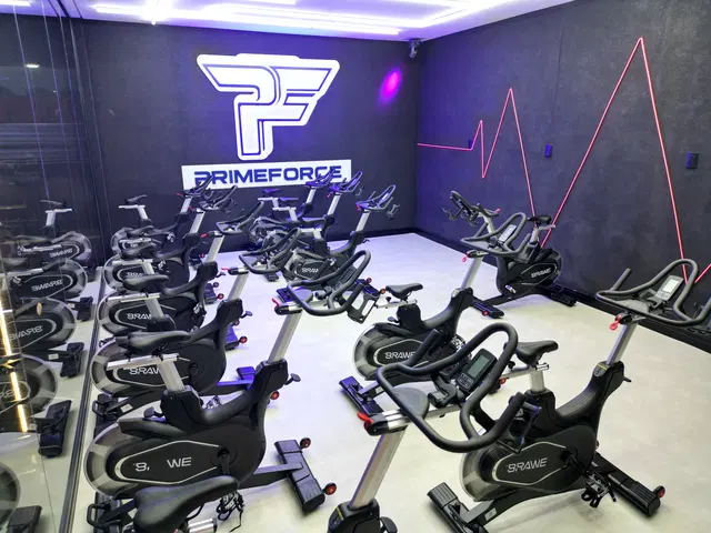 Sala de spinning da Prime Force com bicicletas e identidade PF